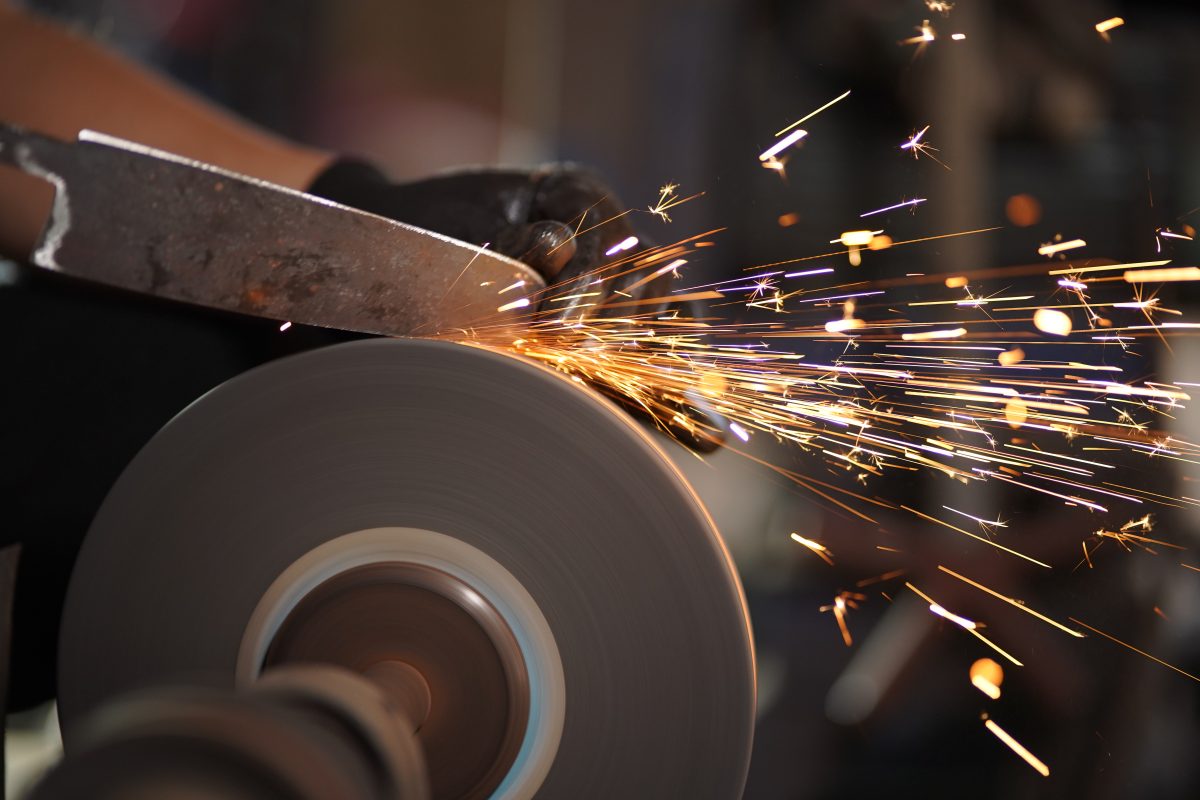Sparks from grinding a hand-forged knife blade